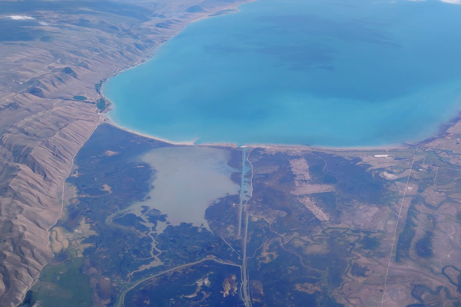 Bear Lake from the air, turquoise water between the hills.